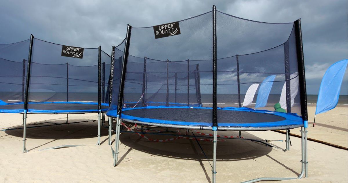 Upper Bounce Trampolines on a beach.