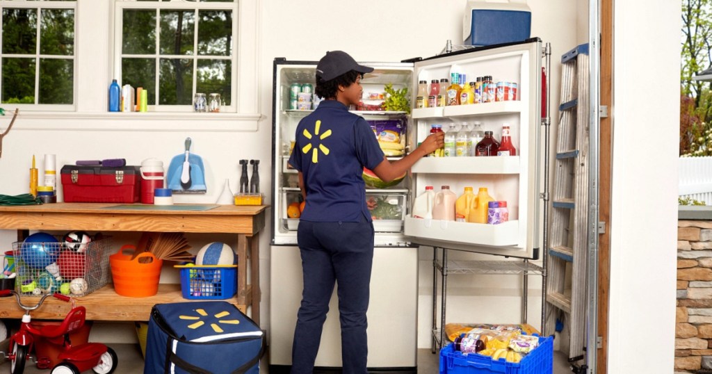 Walmart employee putting groceries away in refrigerator