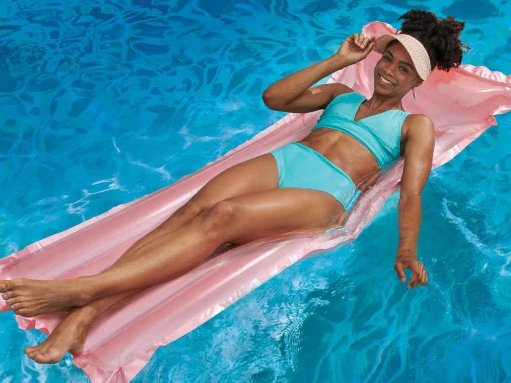 Woman in a pool on a pink raft