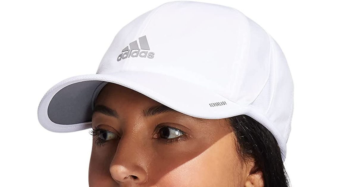 A woman wearing a white Adidas cap 