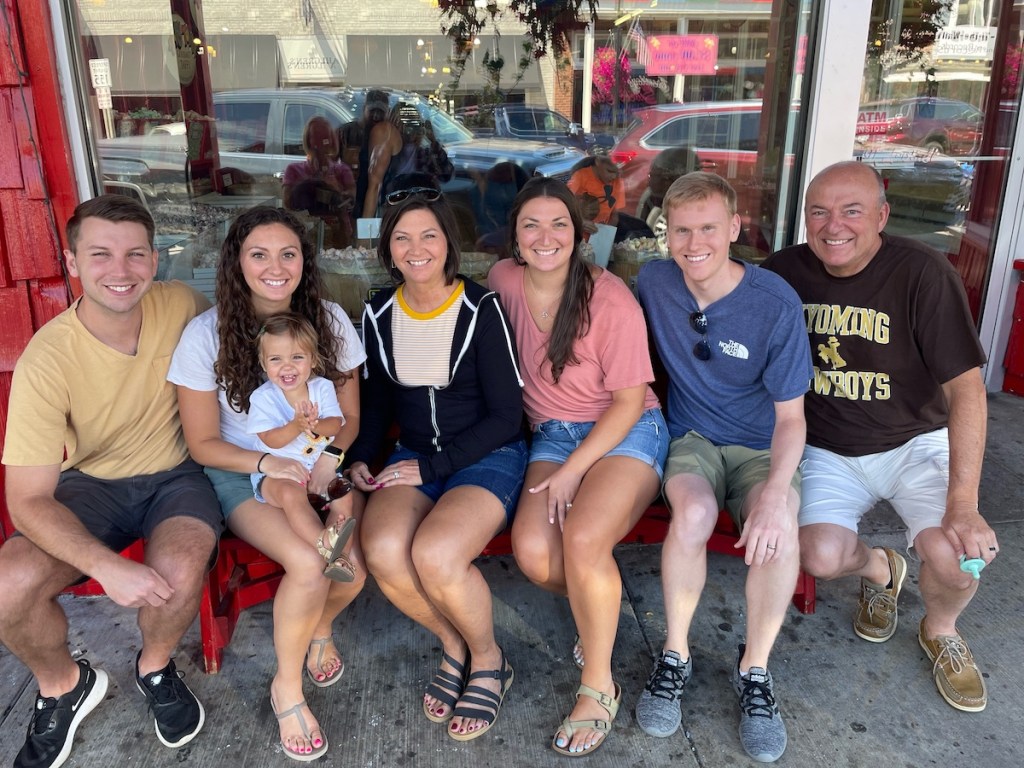 family sitting outside restaurant 