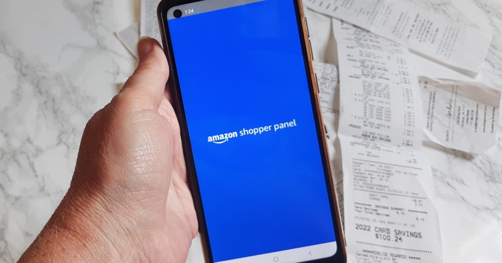 holding a phone showing the Amazon shopper panel app