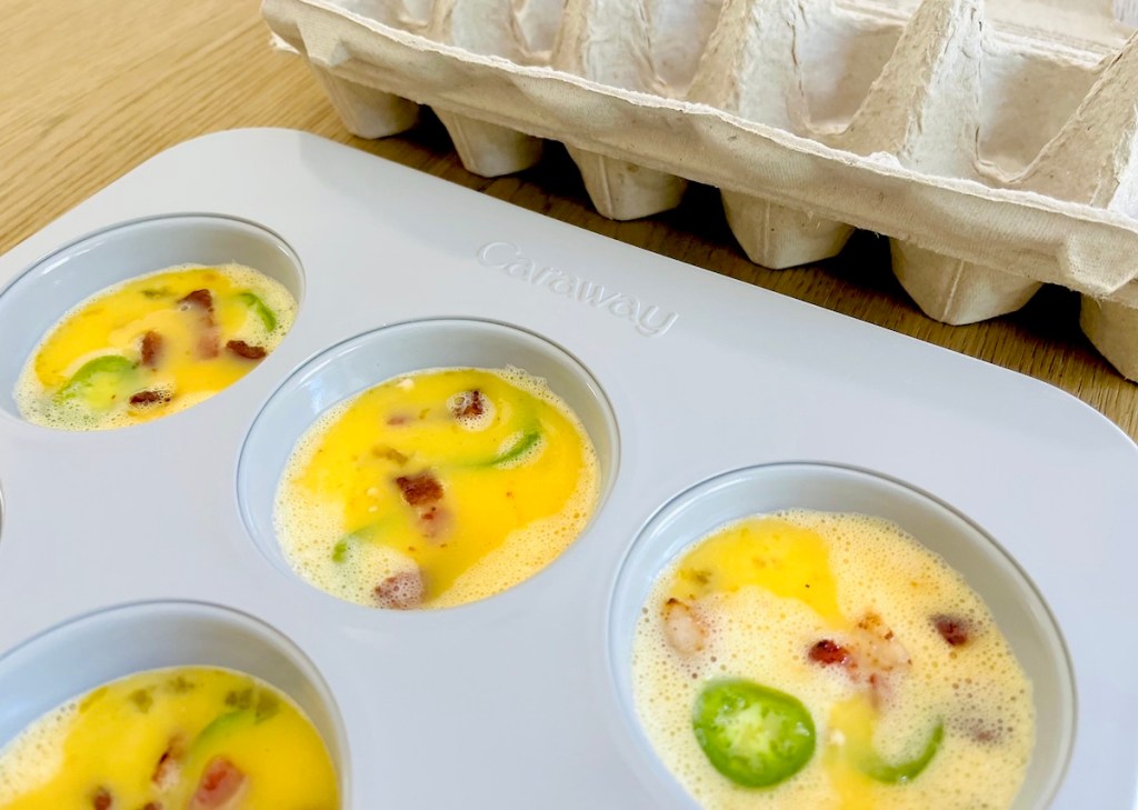 muffin tin with raw egg mixture inside