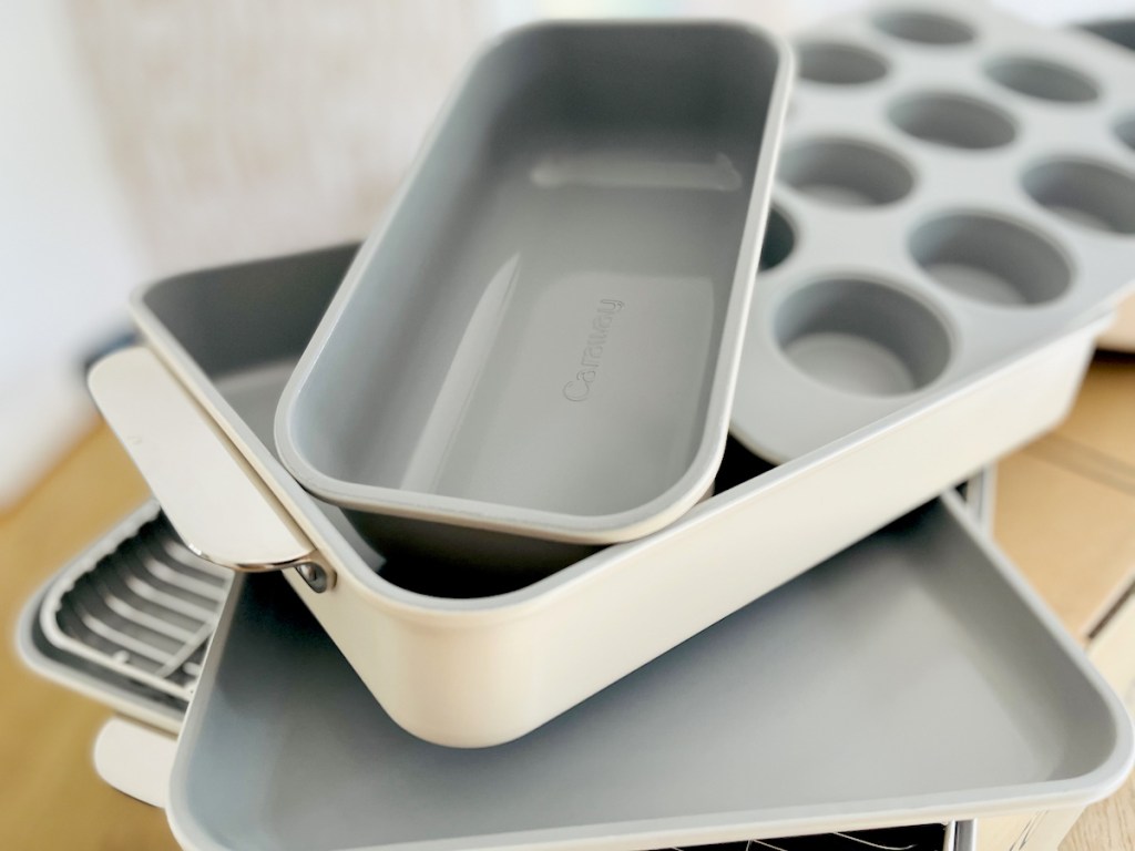caraway bakeware stacked in pile on wood table