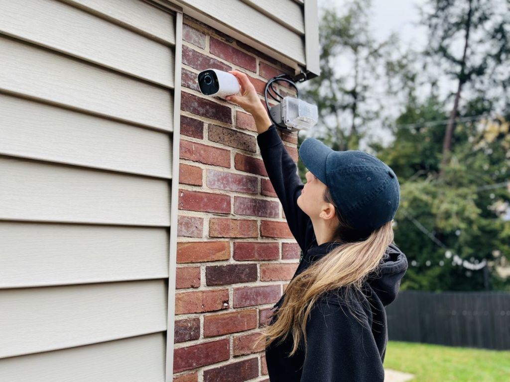 woman installing a eufy security camera