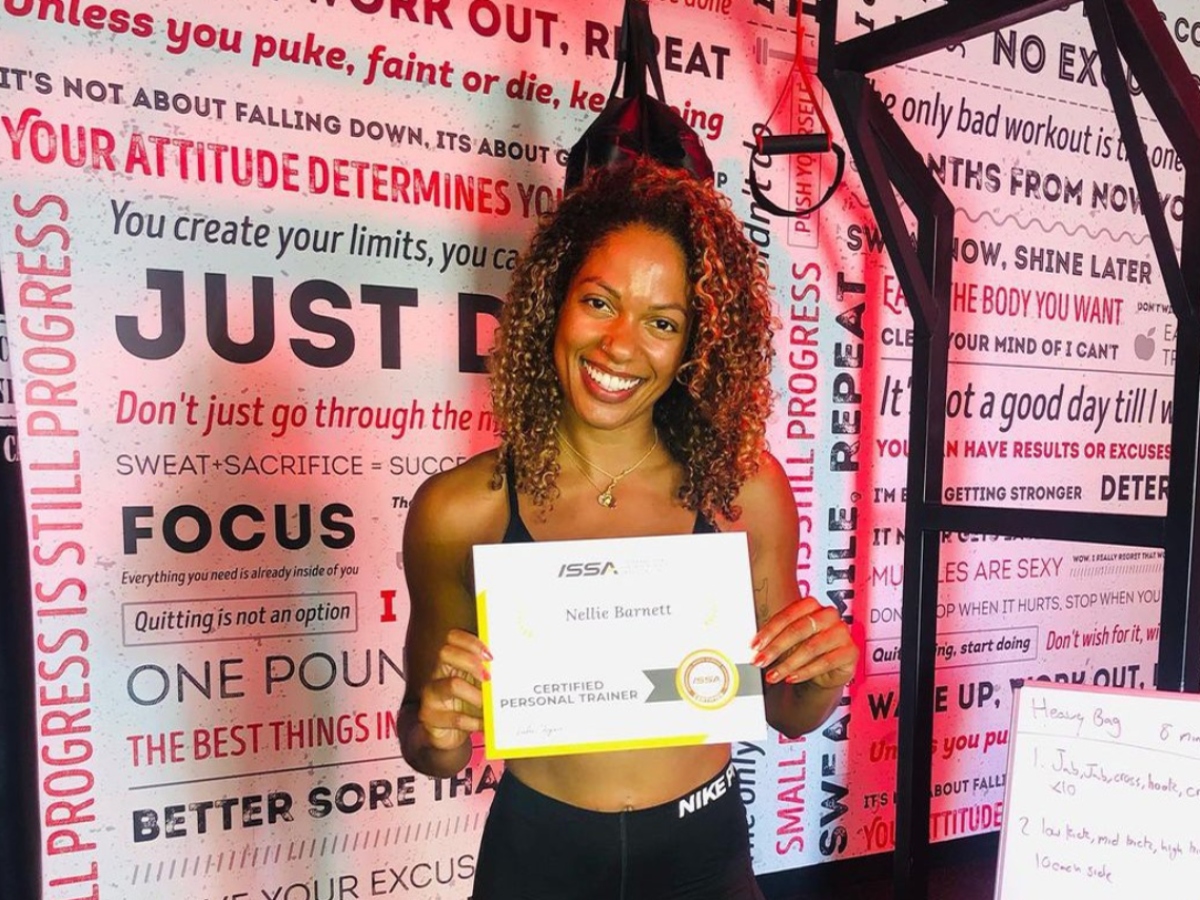 woman holding personal trainer certificate