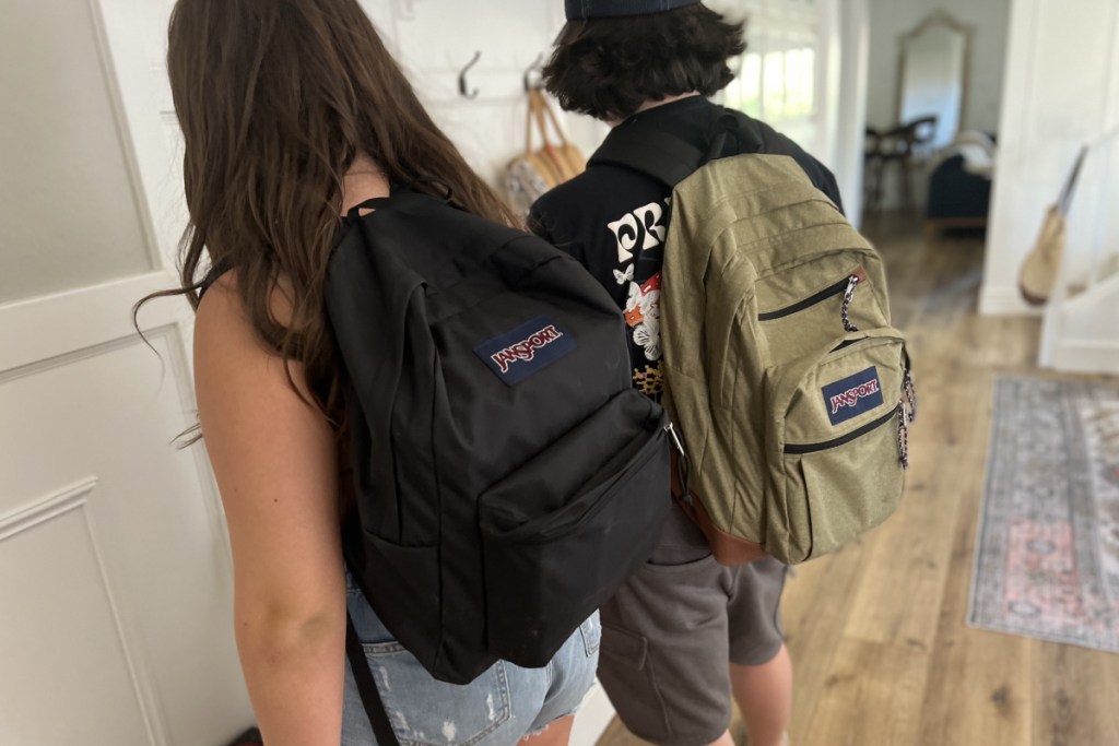 2 teens wearing jansport backpacks