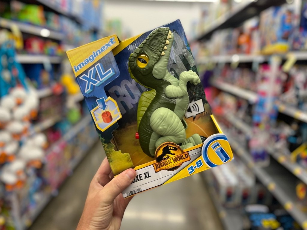 holding a boxed toy dinosaur