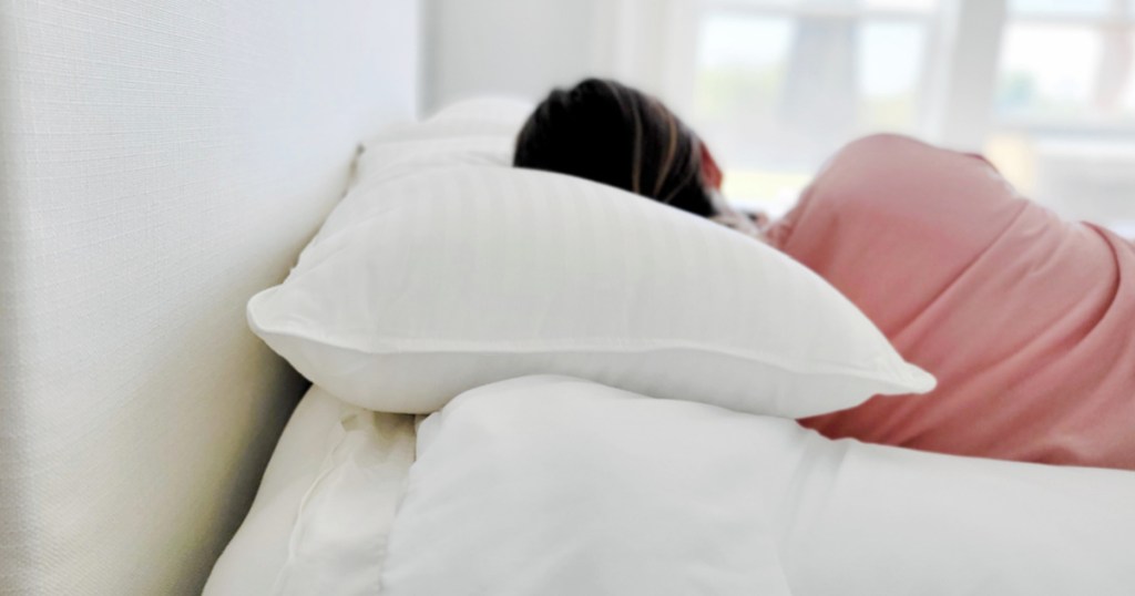 woman laying on pillow on side in bed