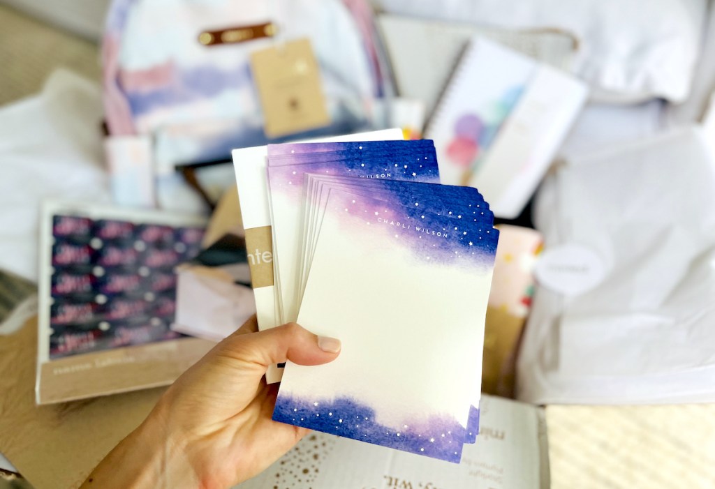 hand holding a stack of galaxy stationery