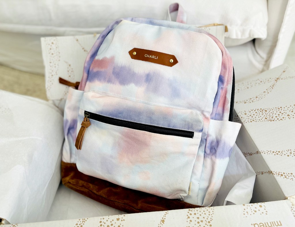 purple and pink tie dye backpack in minted box