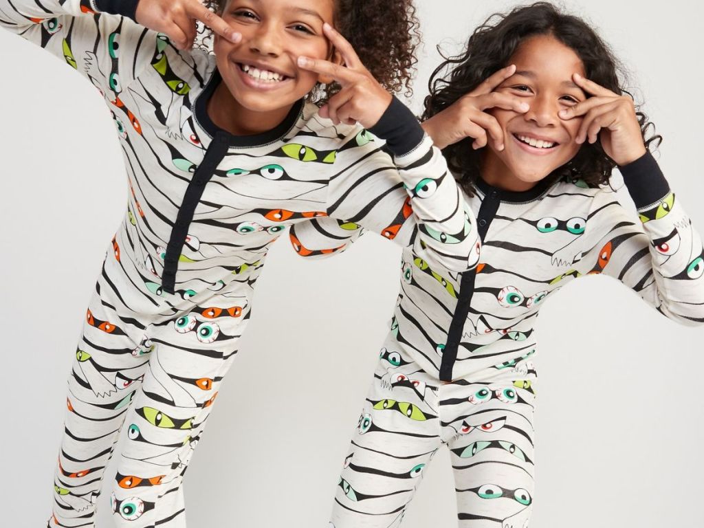kids wearing matching halloween pajamas