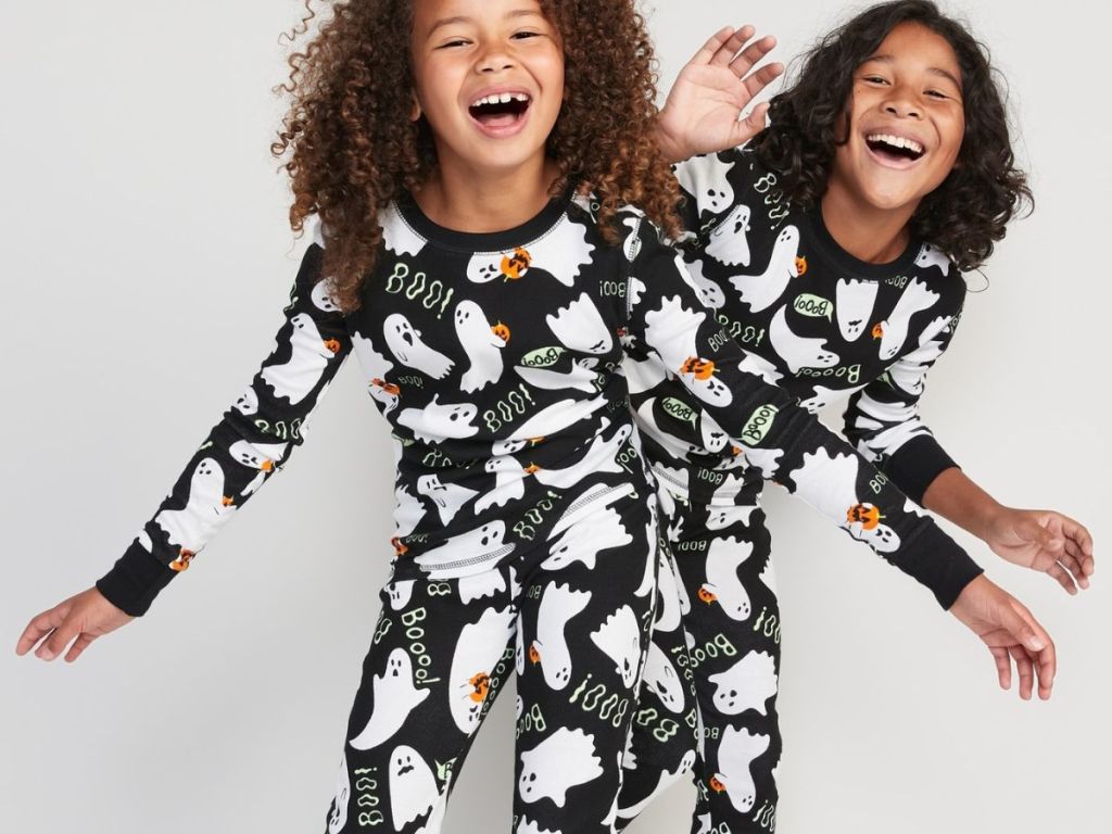 kids wearing matching halloween pajamas