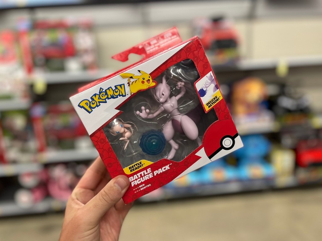 holding a Pokemon battle figure