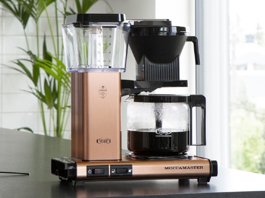 rose gold coffee maker with coffee displayed on it