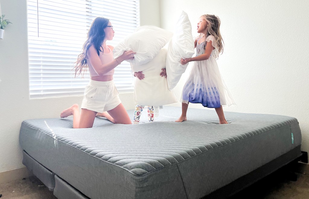 woman and kids having a pillow fight on siena mattress