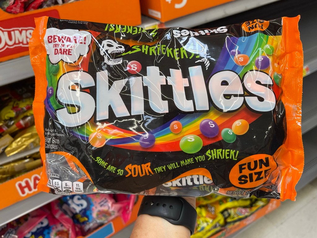 hand holding skittles sours fun size candy 