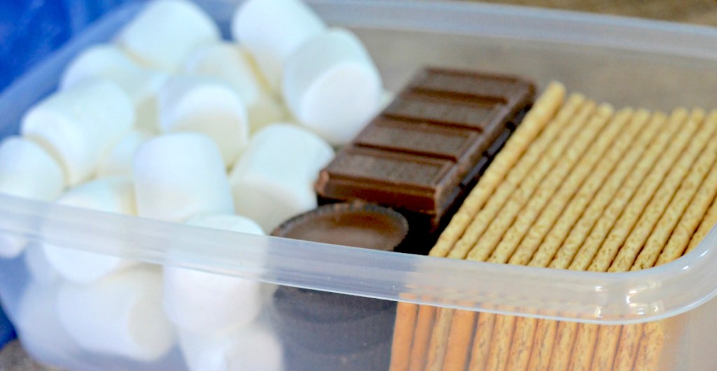 plastic container filled with marshmallows chocolate and graham crackers for smores