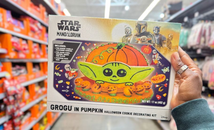 a womans hand holding a grogu halloween pumpkin cookie decorating kit