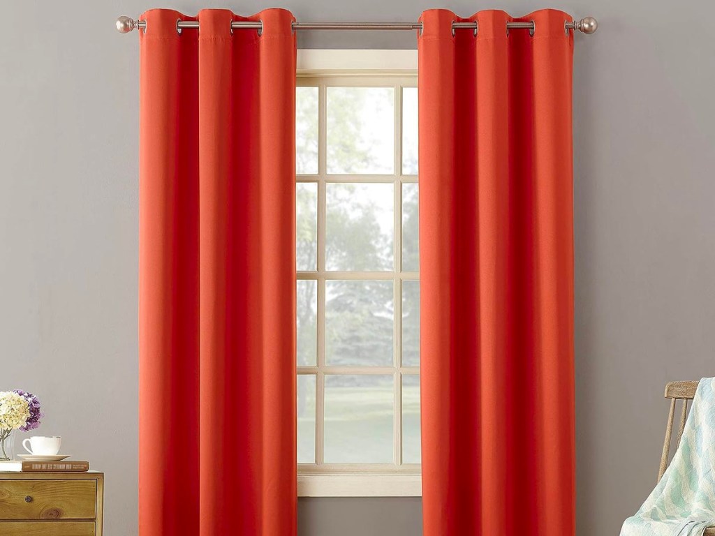 orange curtains hanging at window