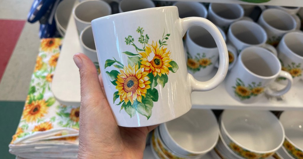 hand holding sunflower mug