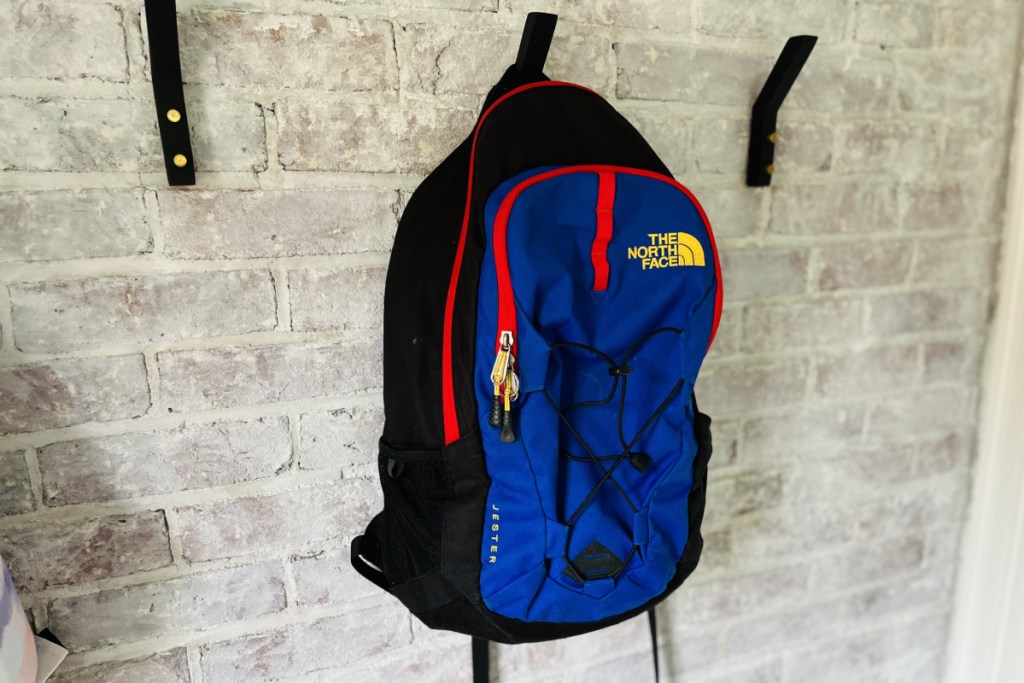 red and blue backpack on hook