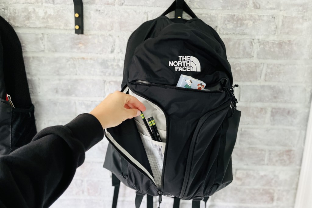unzipped backpack with supplies