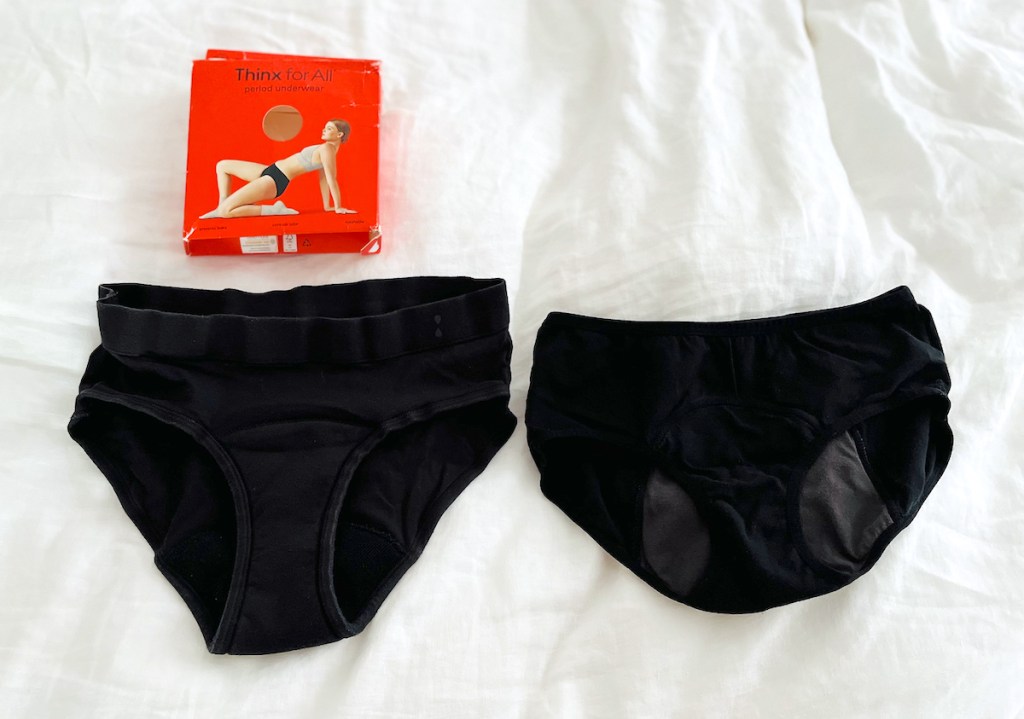 two black pairs of boxer briefs sitting on white sheet