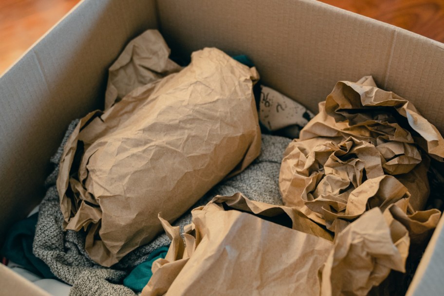 inside of packing tips for moving box with brown packing paper on goods