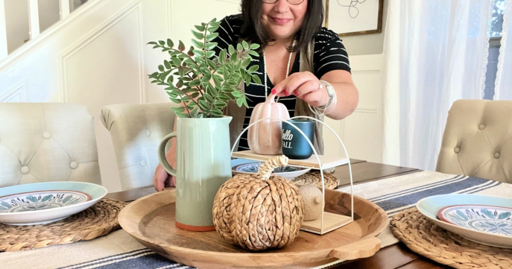 woman using table decorations for fall