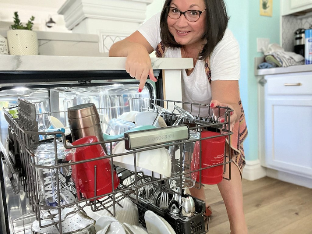 woman opening dishwasher
