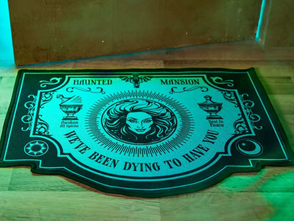 The Haunted Mansion Doormat shown glowing in the dark