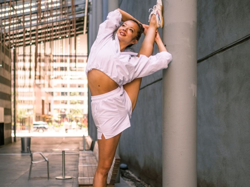 woman doing yoga wearing Alo clothing