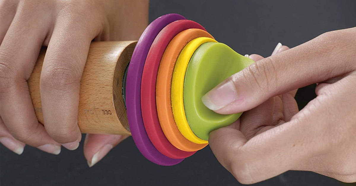 hand adjusting the colorful rings of a joseph joseph rolling pin