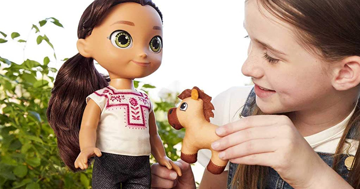 girl outside playing with a spirit untamed doll and small plush horse
