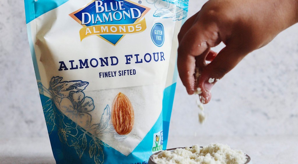Blue Diamond almond flour woman sprinkling into bowl