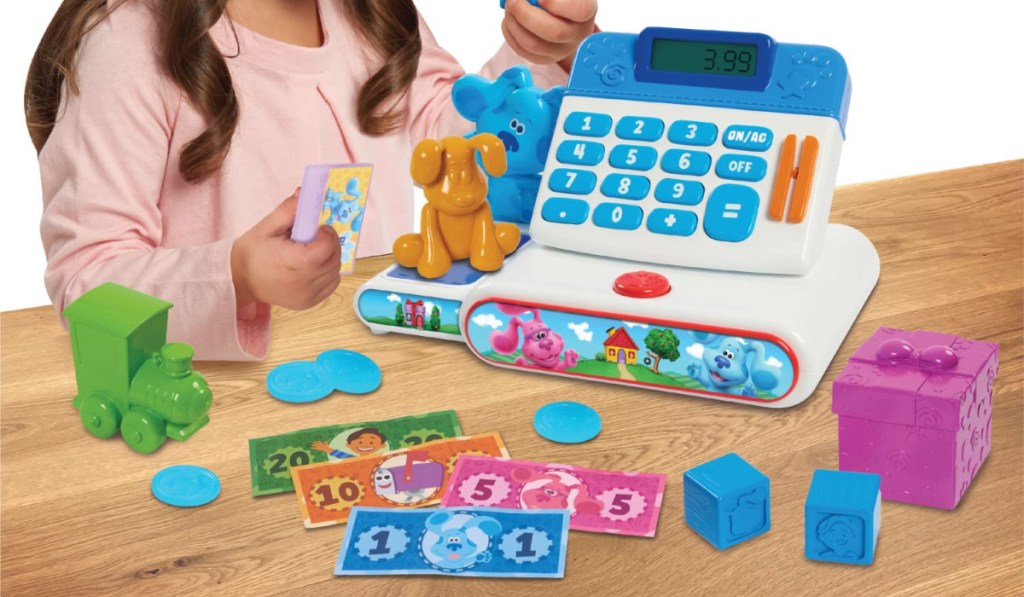 girl playing with Blue's Clues cash register set