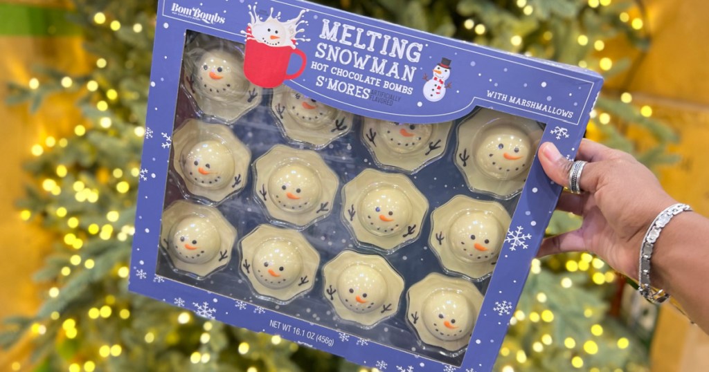 melting snowman style hot cocoa bombs in large package near Christmas tree