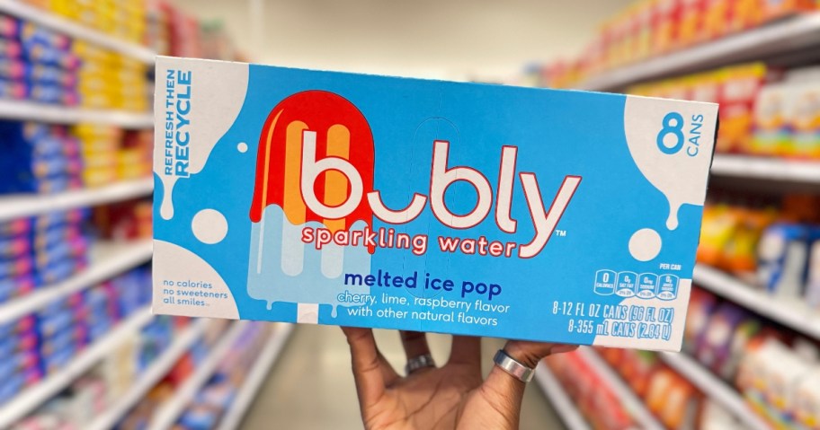 hand holding a box of Bubly Sparkling Water Melted Ice Pop cans in a store aisle