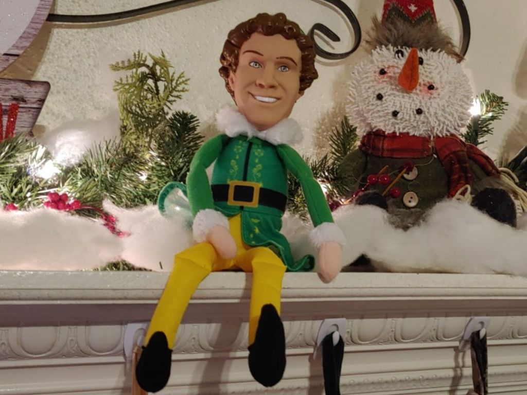Buddy the Elf Plush next to a snowman