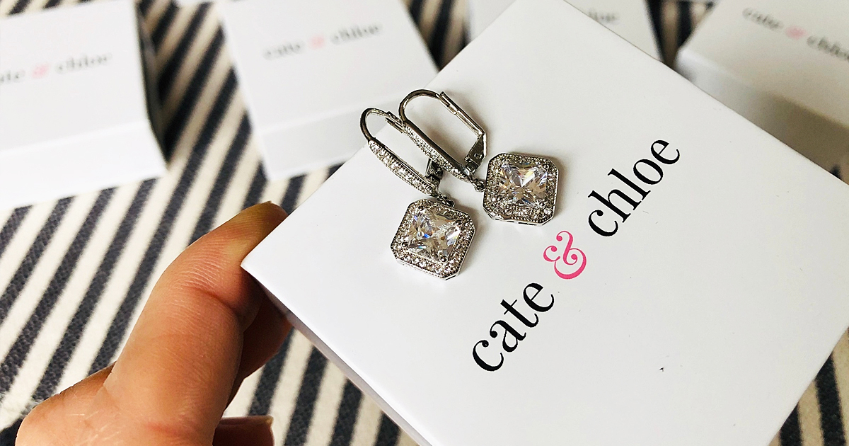 pair of earrings on top of cate & chloe jewelry box
