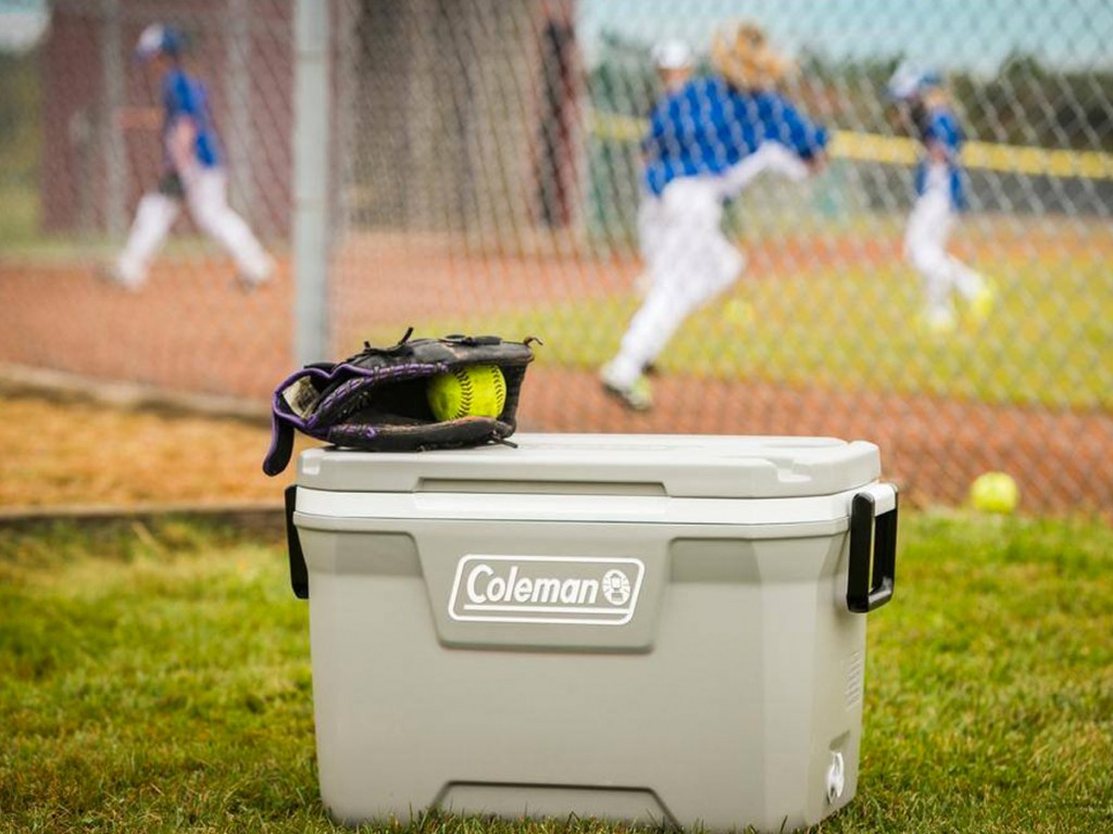 grey coleman cooler with softball mitt on top