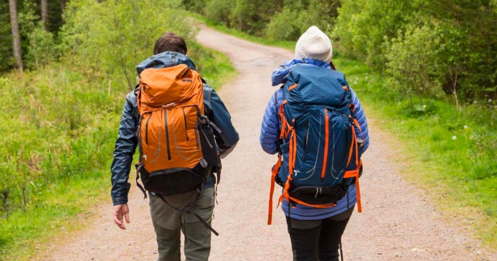 hikers with columbia backpacks on walking trail