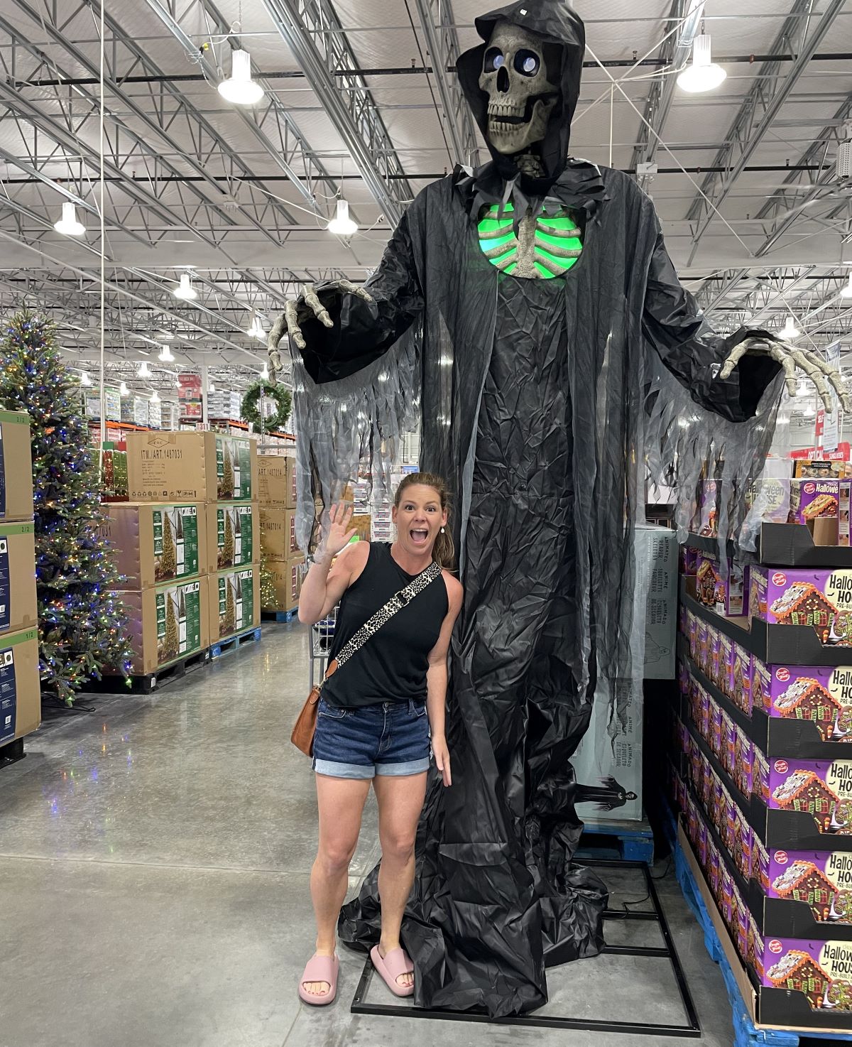 woman standing by a reaper decoration
