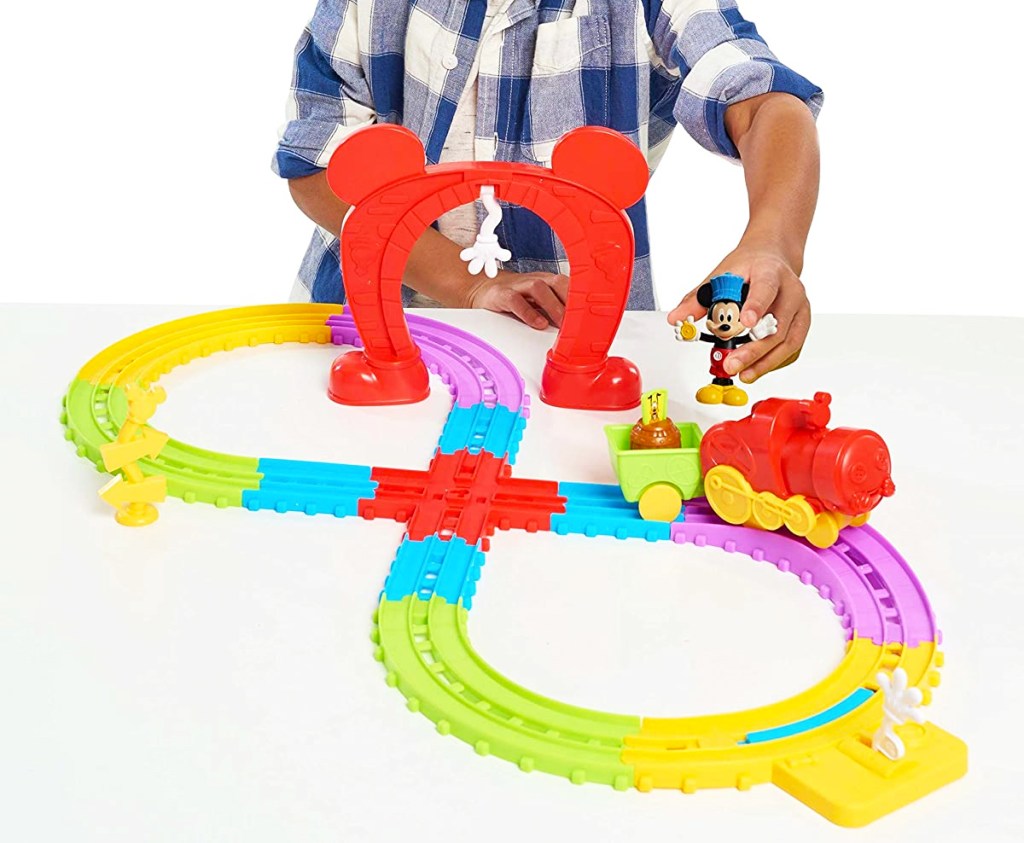 boy playing with Disney Mickey’s Musical Express Train Set