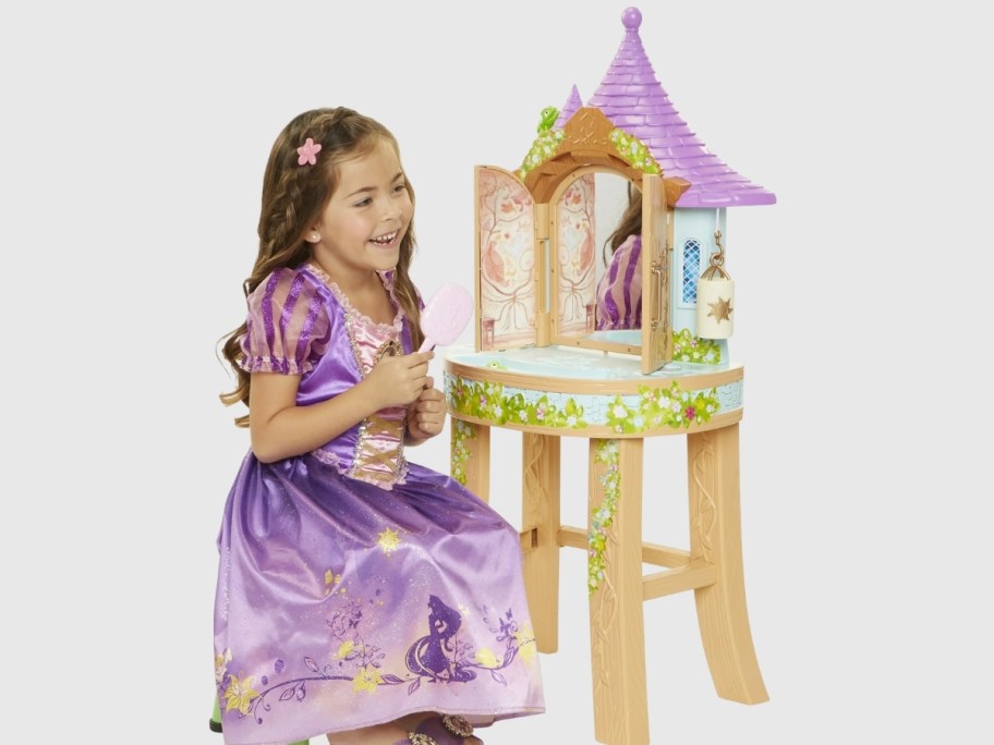 stock image of girl sitting at disney rapunzel vanity play set
