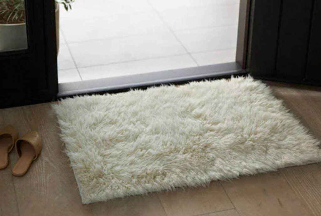 white shag rug in front of patio door