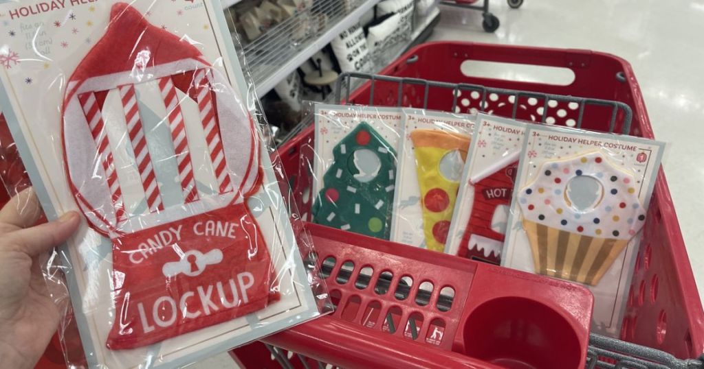 hand holding Elf on the Shelf Costume Target with some in cart