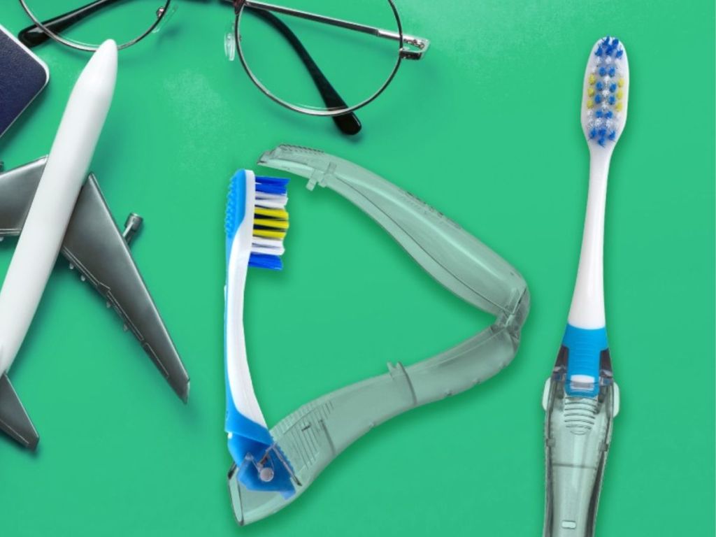Two travel toothbrushes next to an airplane and glasses