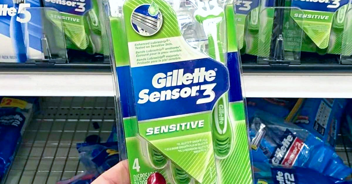 A woman's hand holding a package of Gillette Sensor 3 disposable razors